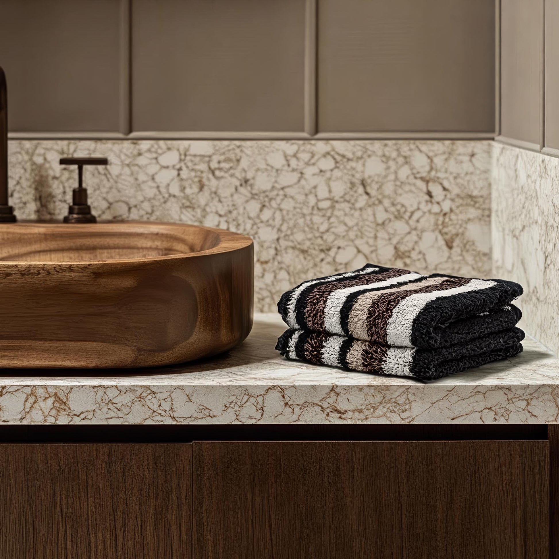 Black and cream striped cotton towels, folded stack