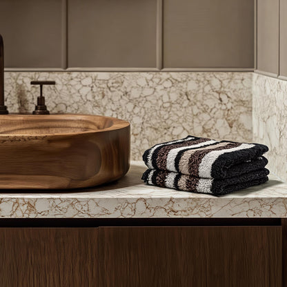 Black and cream striped cotton towels, folded stack