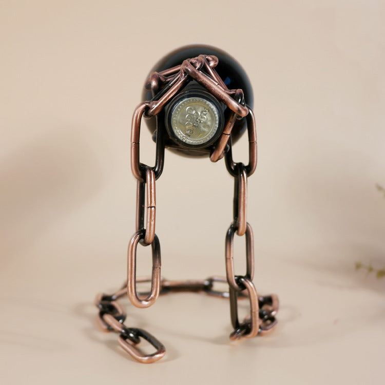 Wine bottle holder with dark bottle and copper-toned chain loop and clasp