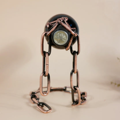 Wine bottle holder with dark bottle and copper-toned chain loop and clasp