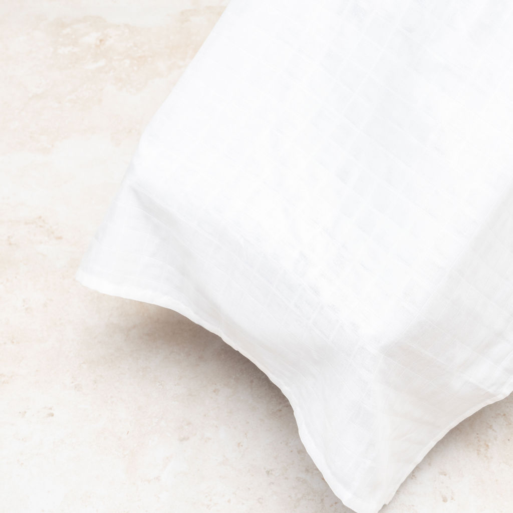 Muslin car seat cover in white with textured diamond weave