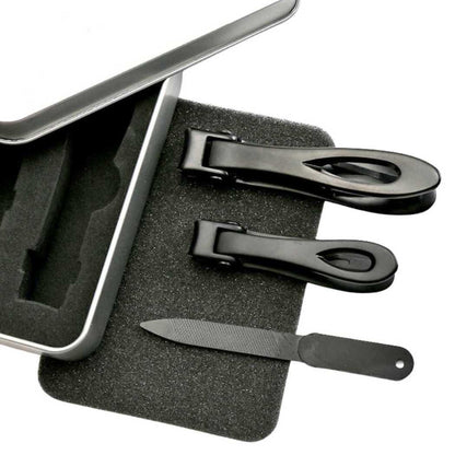 Nail clipper tools and emery file in black foam tray.