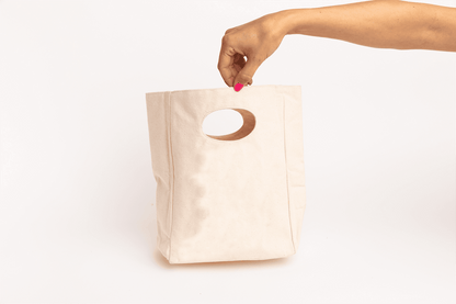 Canvas lunch bag with oval cutout handle, plain front with no visible print