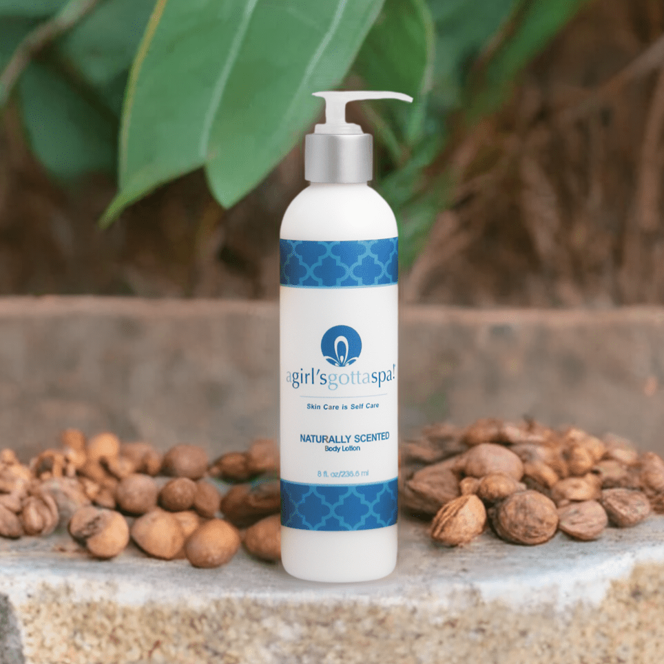 Body lotion bottle with silver pump and blue patterned label, upright