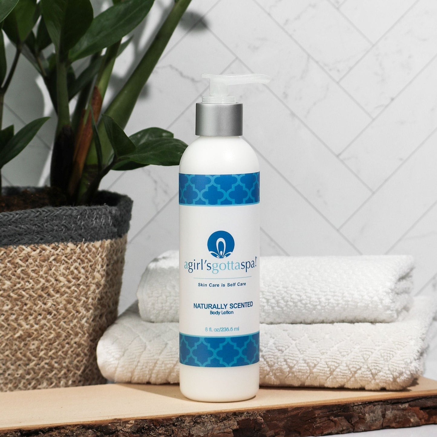 Body lotion bottle with silver pump and blue patterned label