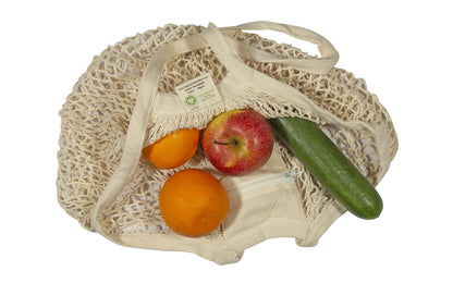 Cream mesh produce bag with long handles, filled with apples, orange, and cucumber