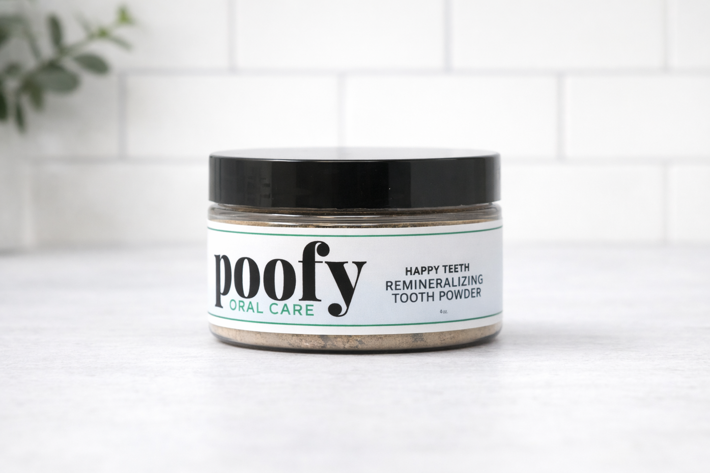 Happy Teeth tooth powder jar with black lid and green accent label text.