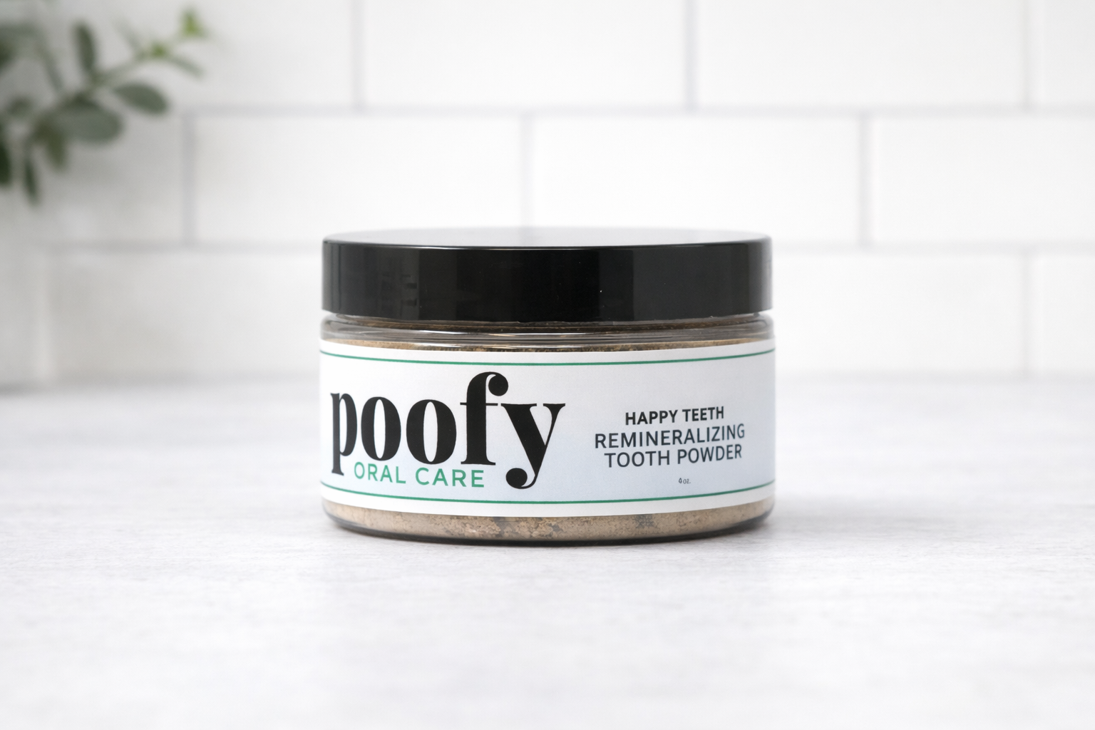 Happy Teeth tooth powder jar with black lid and green accent label text.