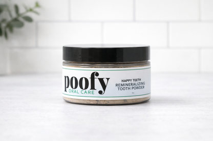 Happy Teeth tooth powder jar with black lid and green accent label text.