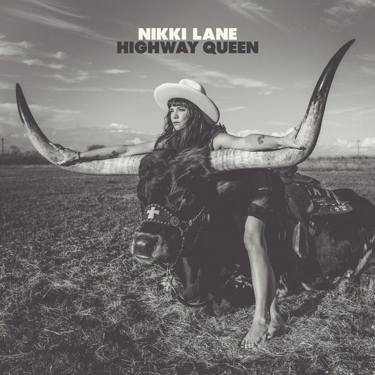 Album cover art with woman in white hat and horned bull in outdoor scene