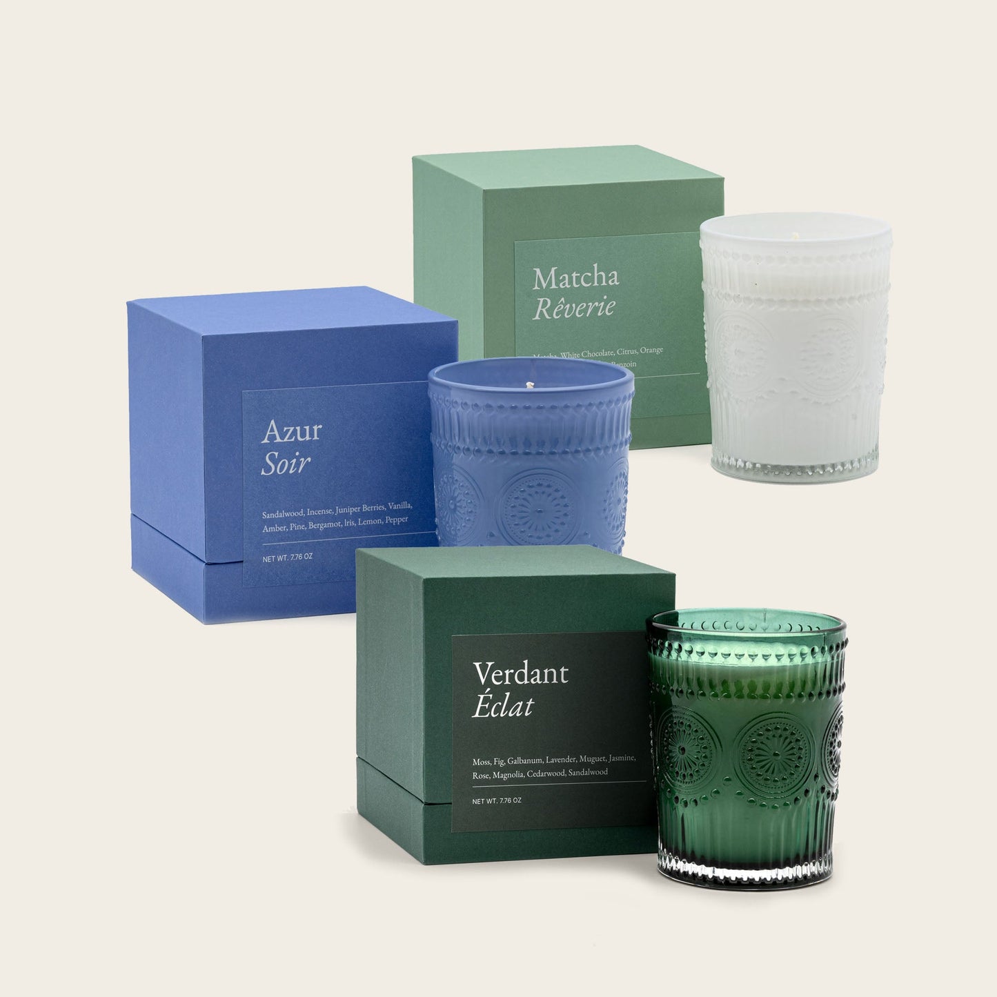 Scented candle set with blue, green, and white glass jars and gift boxes
