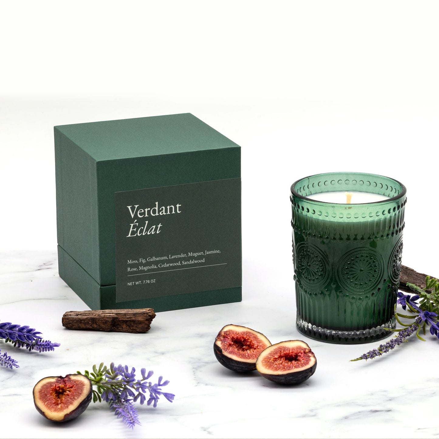 Green "Verdant Éclat" gift box with matching embossed glass candle, lit