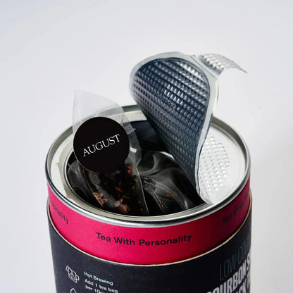 Metal tea tin with a mesh infuser and folded tea sachets