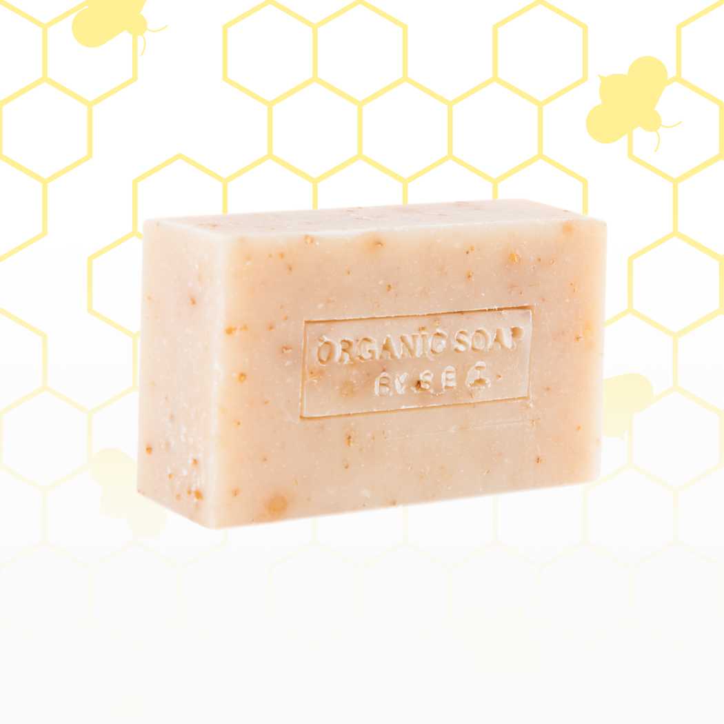 Organic bar soap, pale beige bar with tiny specks and embossed label.