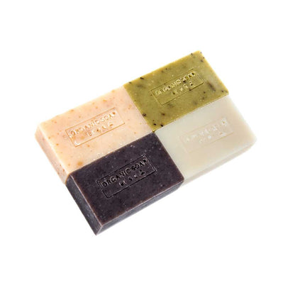 Organic bar soap, multi-color stacked bars: pink, green, dark, cream.