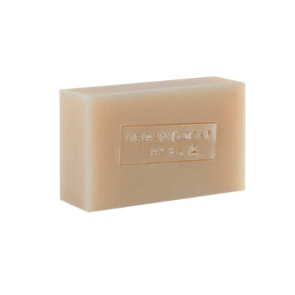 Organic bar soap, creamy off-white bar with embossed label and smooth texture.
