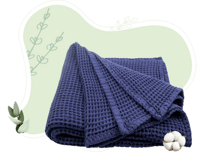 Deep blue waffle weave throw blanket folded with visible waffle pattern.