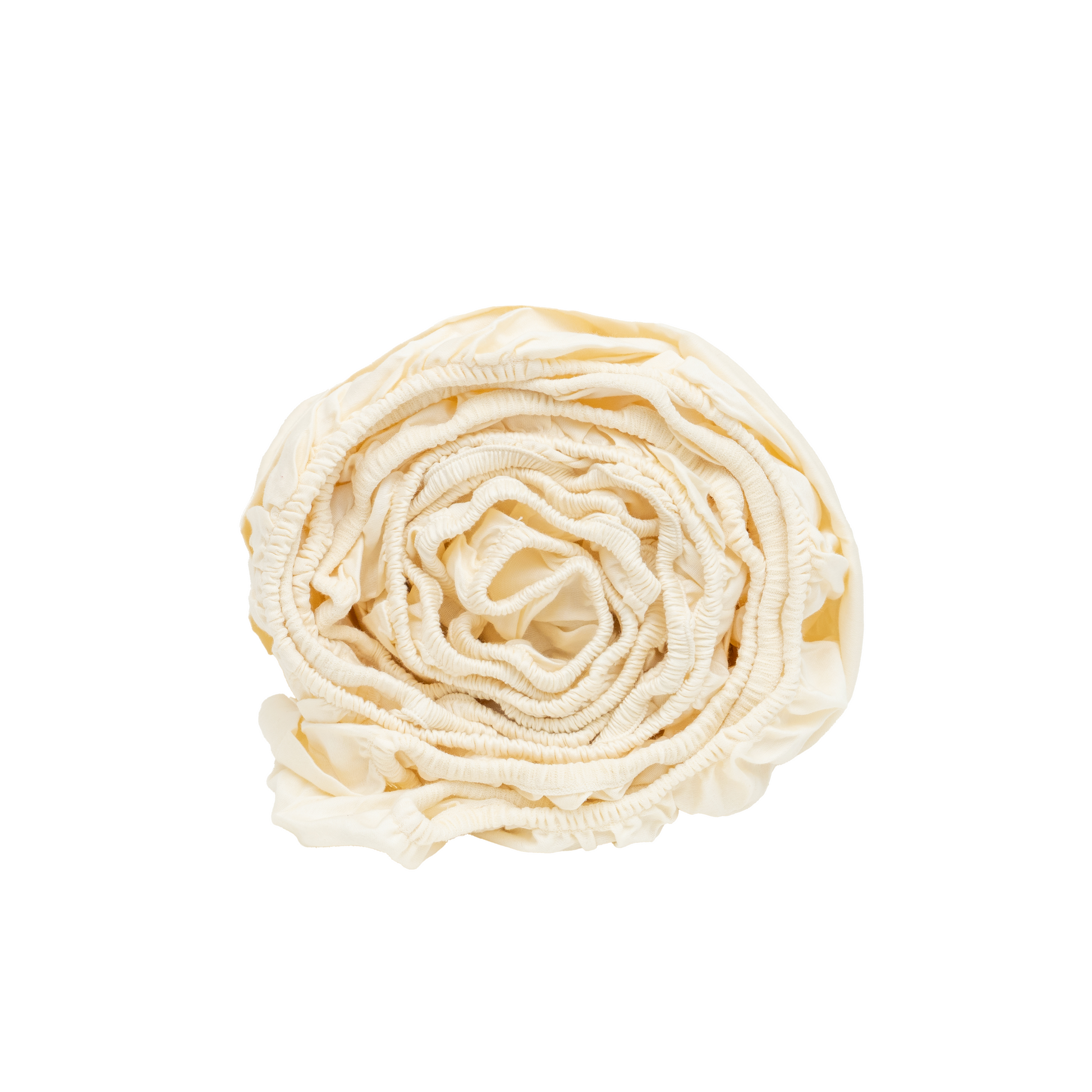 Organic sateen fitted sheet in natural cotton, neatly folded with ruffled edges