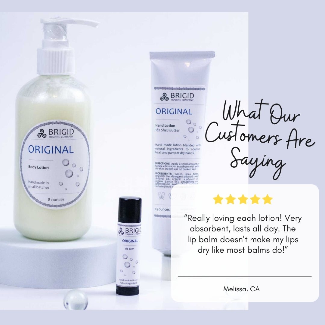 Natural lip balm tube with black cap and white label, shown with skincare items