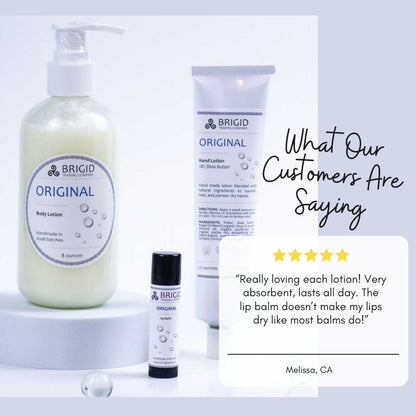 Natural lip balm tube with black cap and white label, shown with skincare items