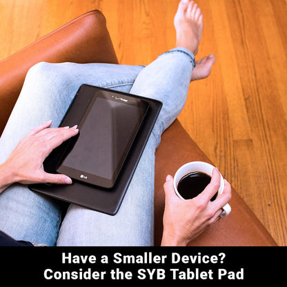 Black tablet pad with a corner logo, holding a small device on a couch.