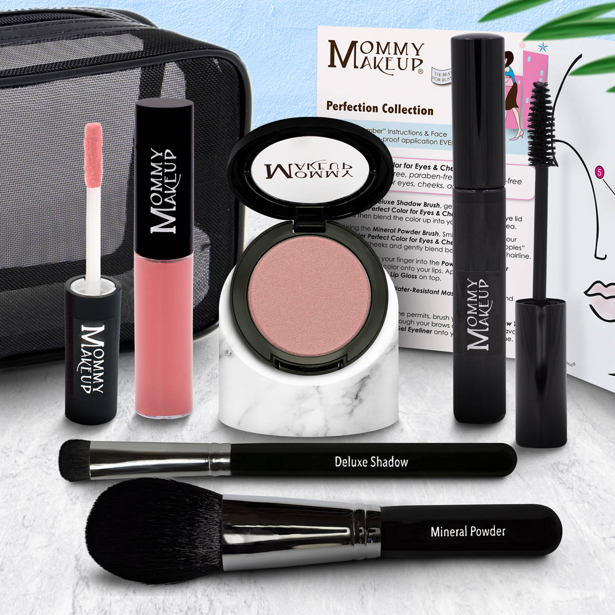Makeup set with eyeshadow compact, pink-coral lip color tube, and two black brushes