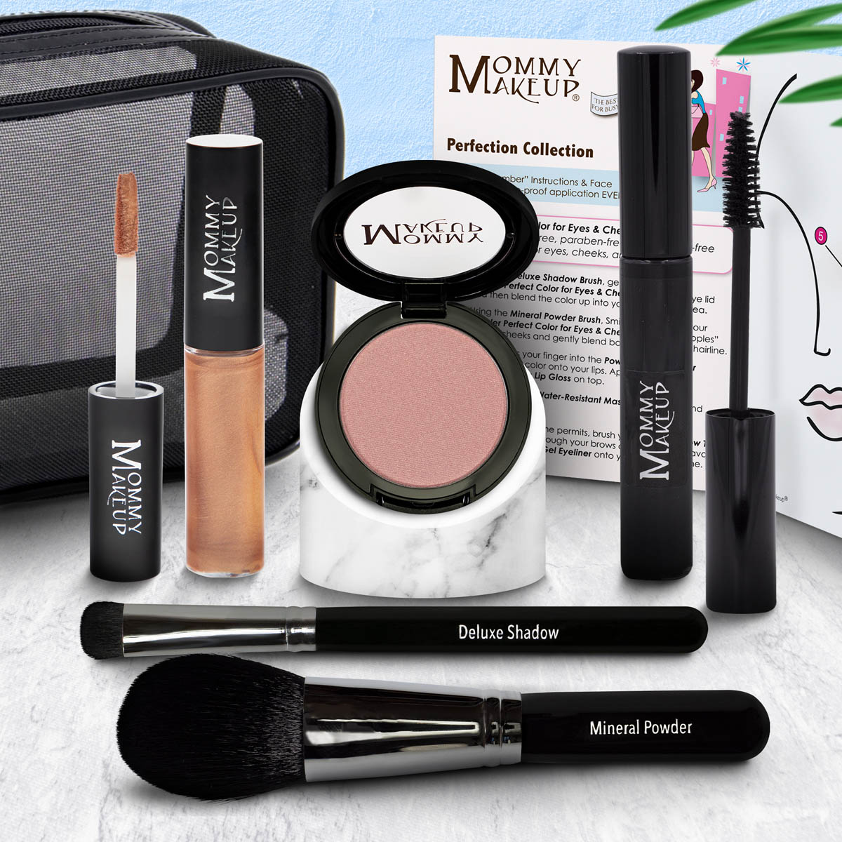 Makeup set with eyeshadow compact, warm tan lip color tube, and two black brushes