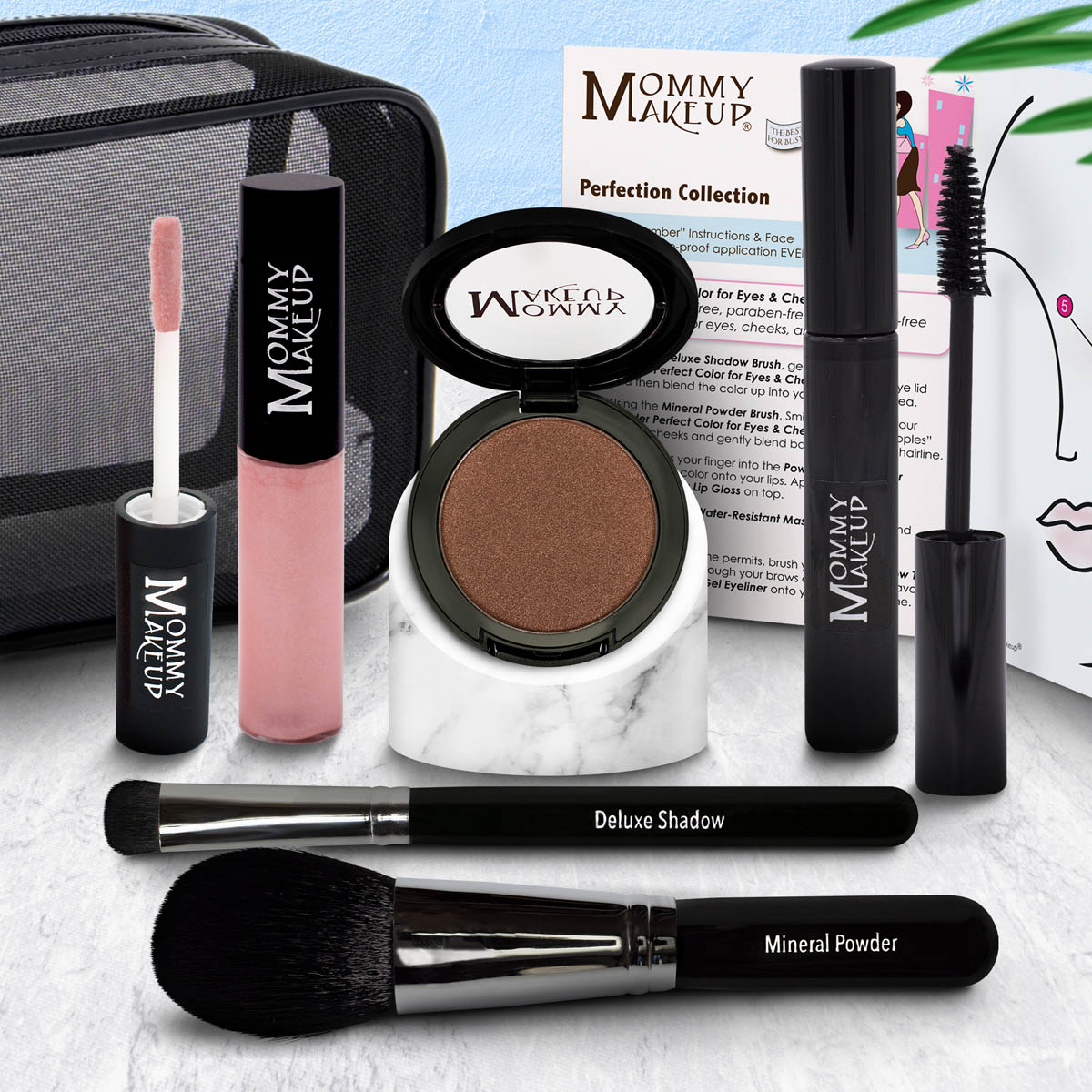 Makeup set with compact powder, pink lip product, and two makeup brushes