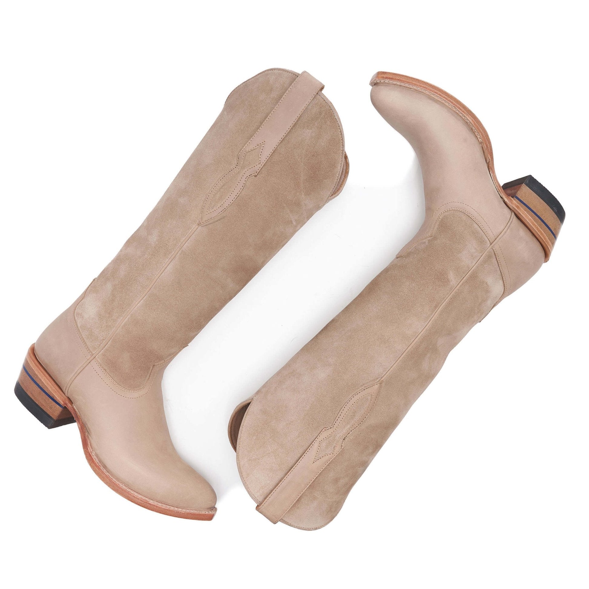 Pair of tan suede cowboy boots with almond toe and block heel