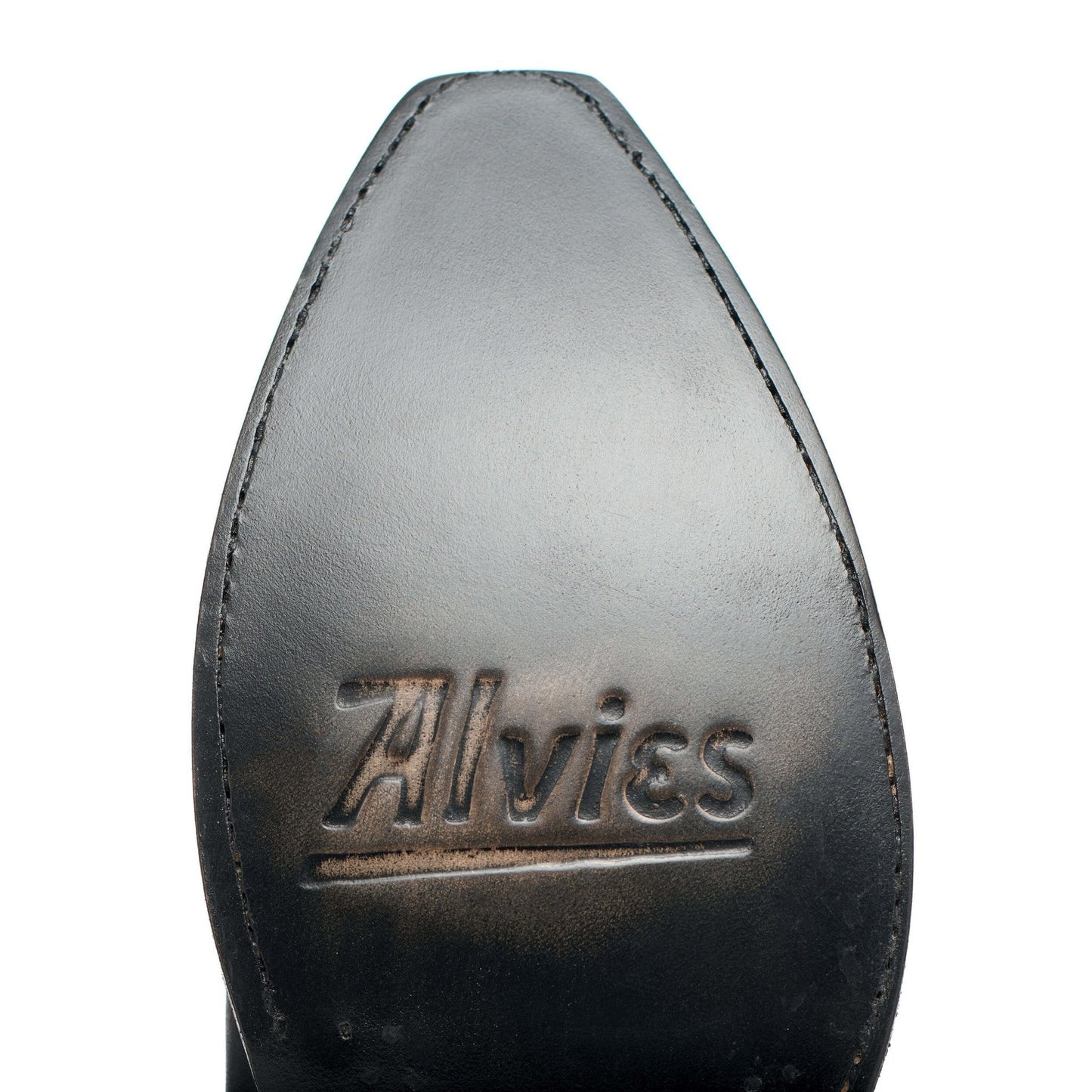 Cowboy boot toe with Alvies logo, dark leather and edge stitching