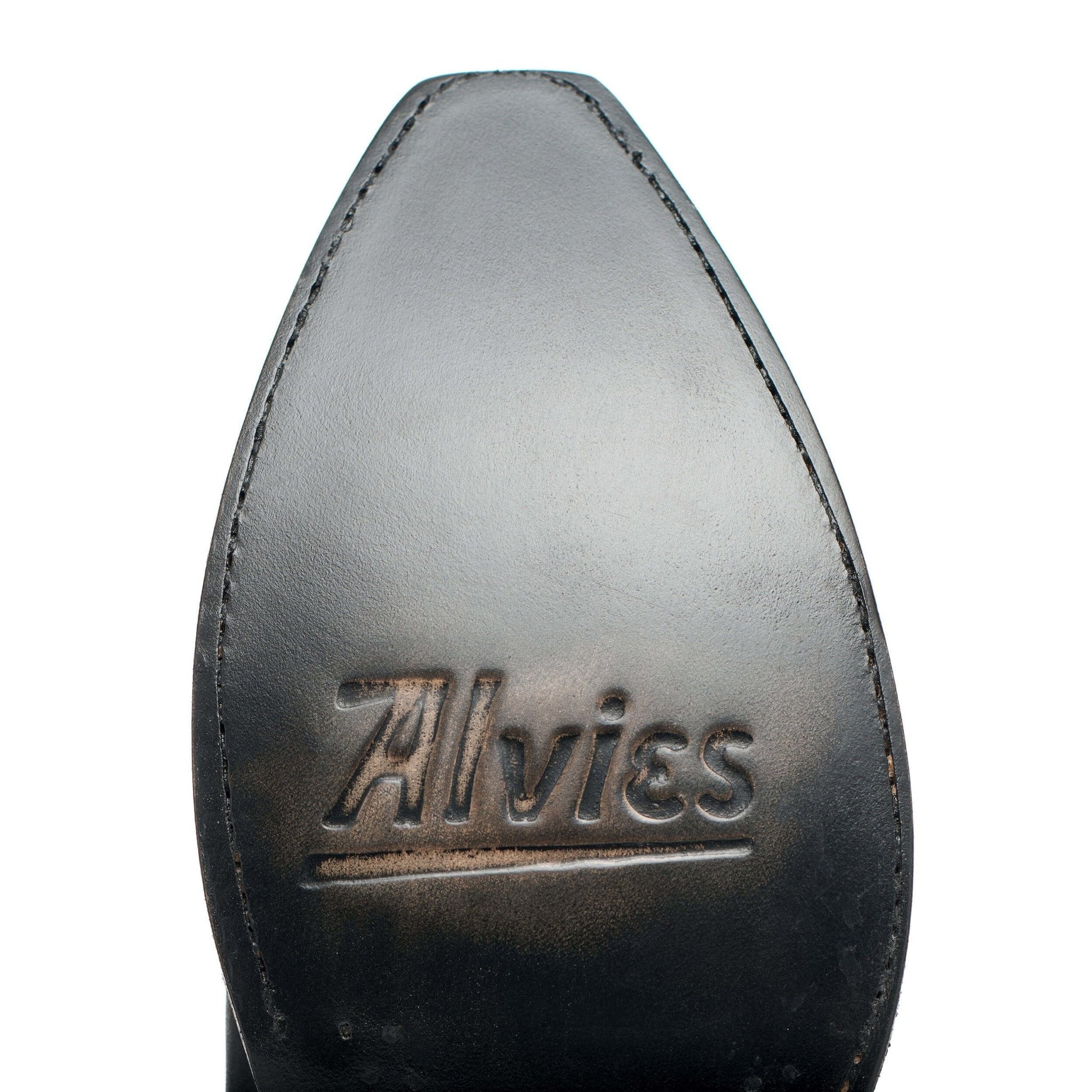 Cowboy boot toe with Alvies logo, dark leather and edge stitching