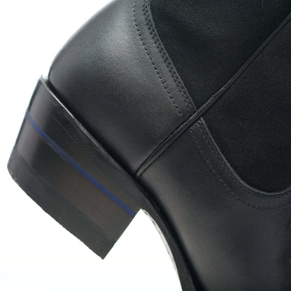 Black leather cowboy boot with stacked heel and angled side panel stitching