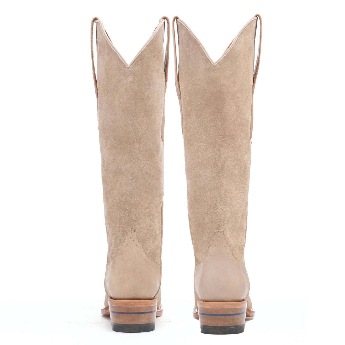 Pair of taupe suede cowboy boots with stacked heels and pointed toes.