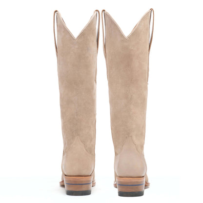 Pair of taupe suede cowboy boots with stacked heels and pointed toes.