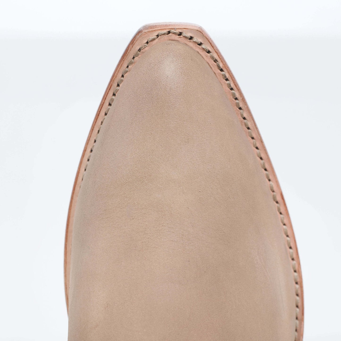 Tan suede boot upper with curved top and neat stitched seams