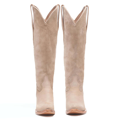 Light taupe suede cowboy boots, tall mid-calf with V-notch top and pointed toe.