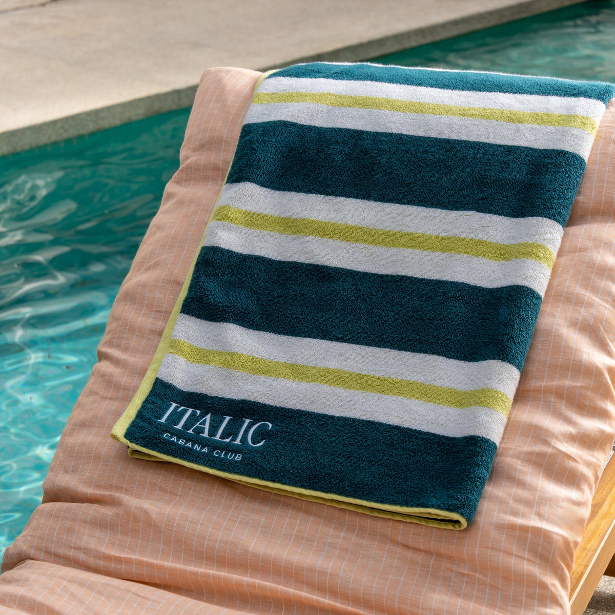 Striped cotton beach towel in teal with pale yellow-green and white bands