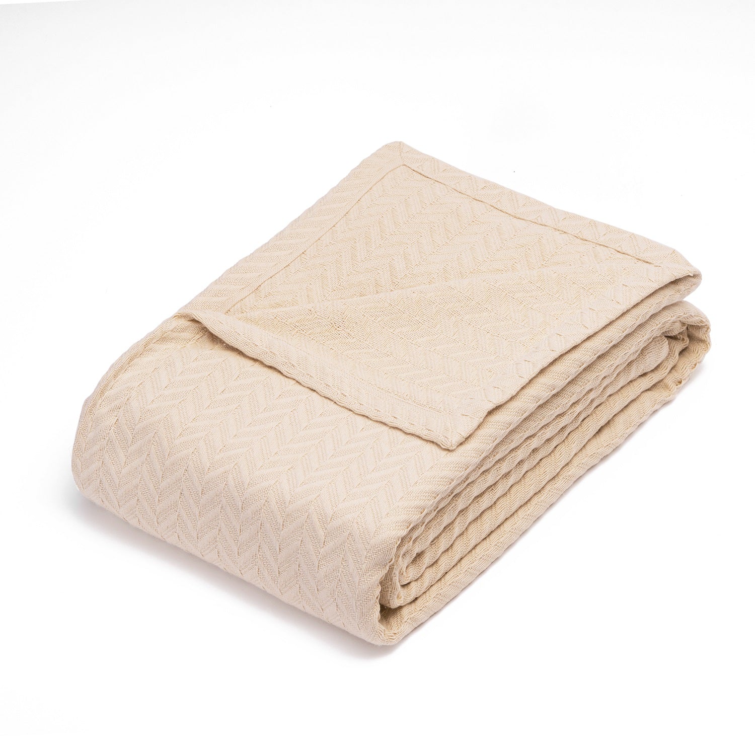 Herringbone cotton blanket, ivory, neatly folded with chevron knit texture
