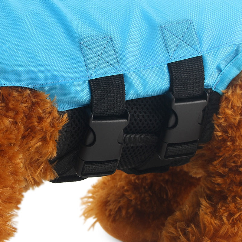 Dog life vest in blue with black buckles and side padding detail