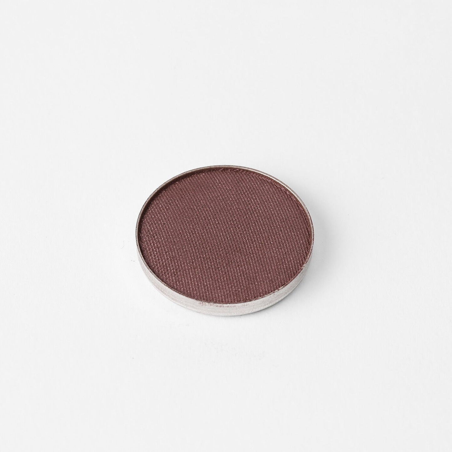 Pressed eyeshadow pan, deep mauve-brown shimmer