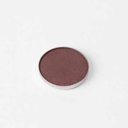 Pressed eyeshadow pan, deep mauve-brown shimmer