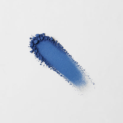 Pressed eyeshadow swatch, bright blue shimmer powder with sparkles.