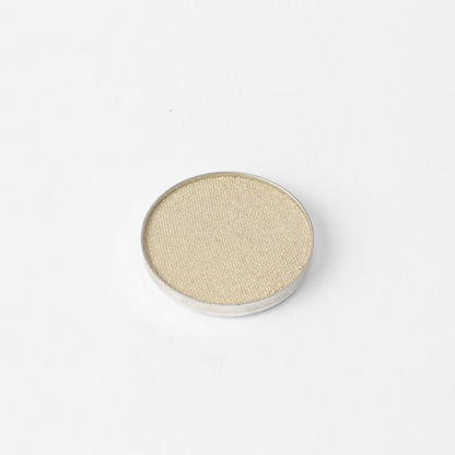 Pressed eyeshadow pan, soft gold-beige shimmer