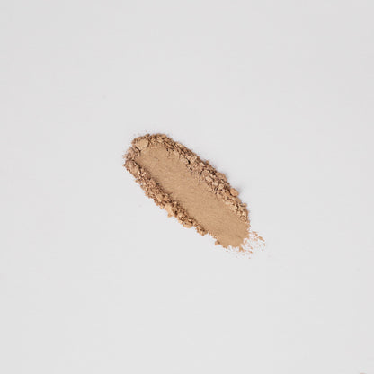 Pressed eyeshadow swatch in warm bronze shimmer with soft dusting