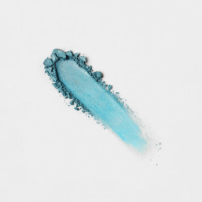 Light teal pressed eyeshadow swatch with powdery smear