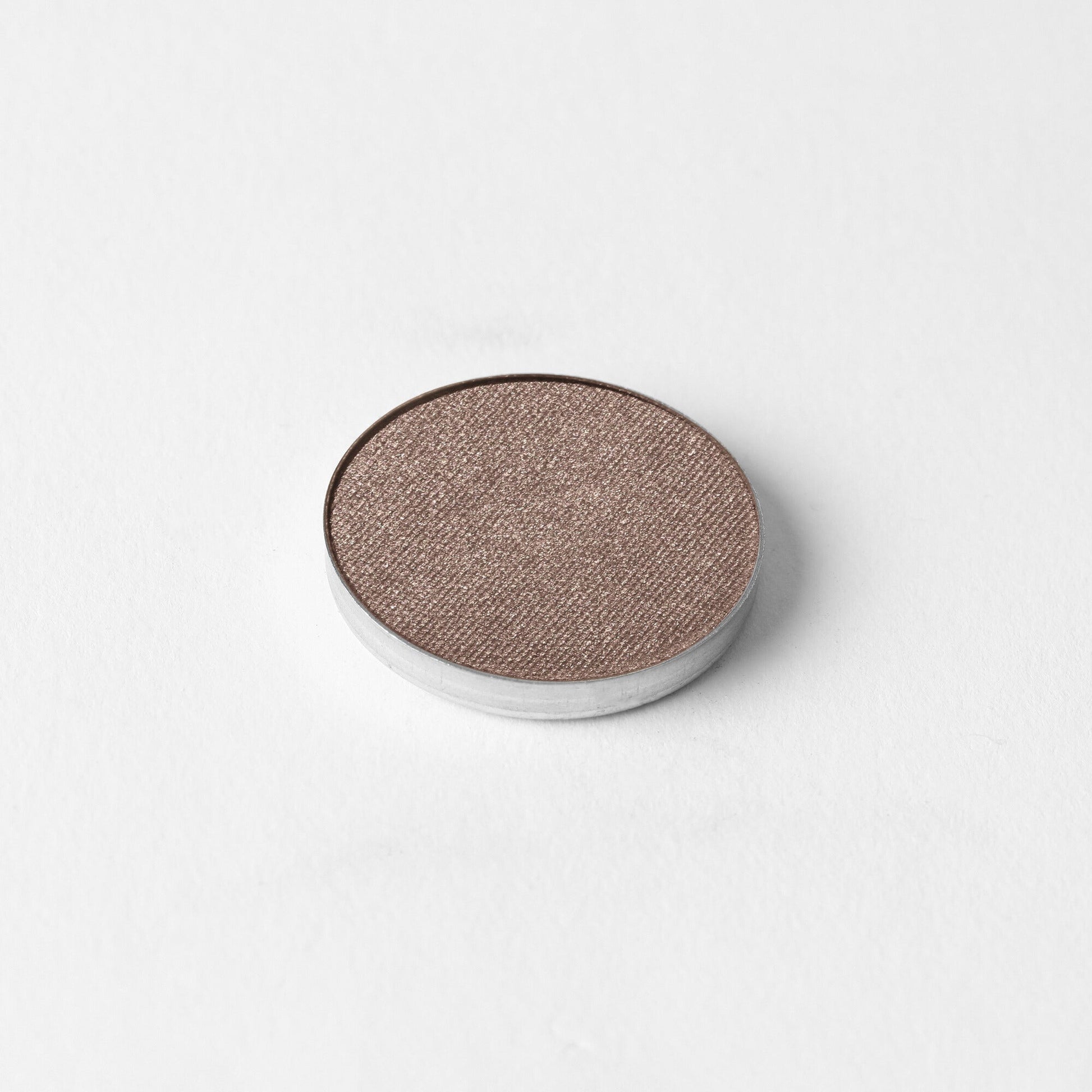 Pressed eyeshadow pan with rose-brown shimmer finish in a round compact