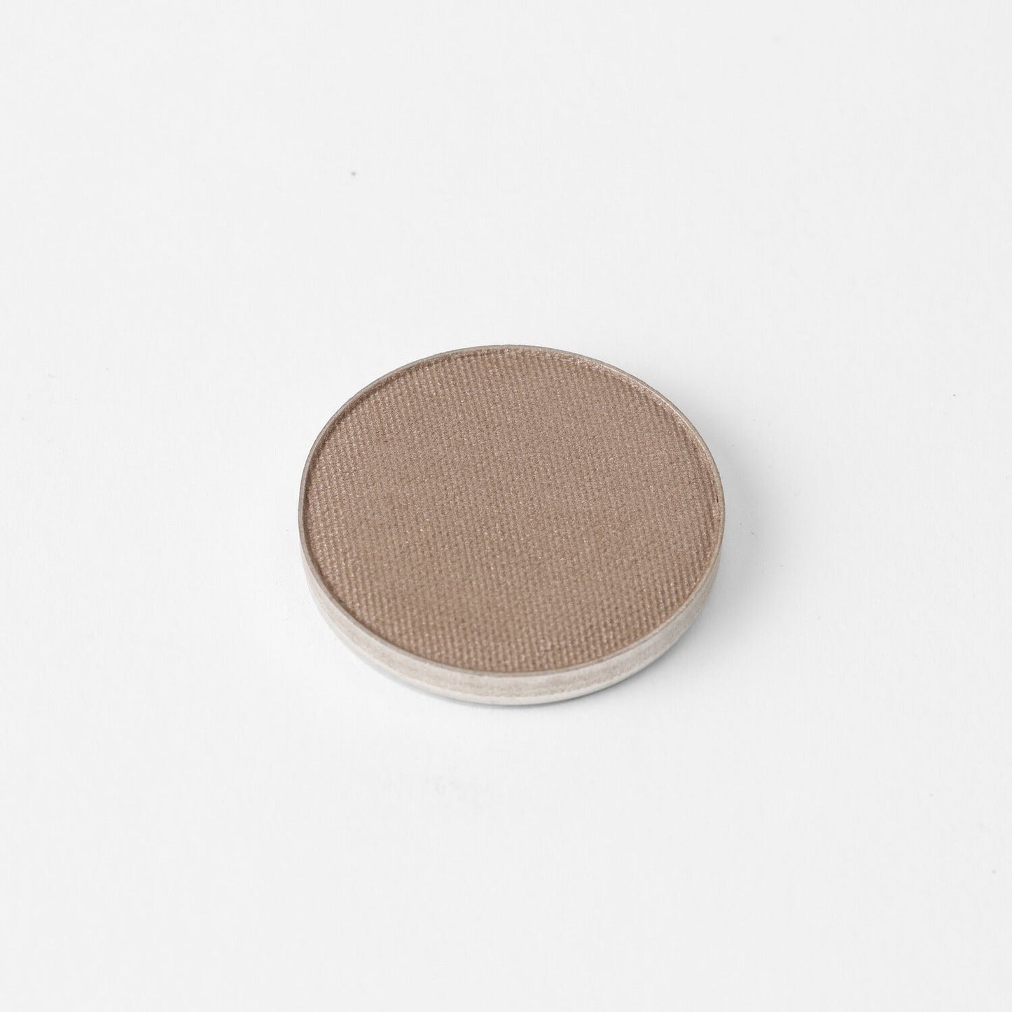Pressed eyeshadow pan with medium taupe brown matte-shimmer finish