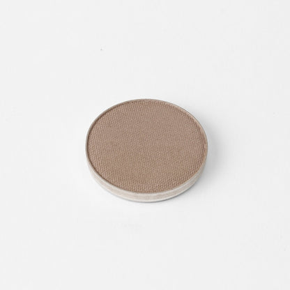 Pressed eyeshadow pan with medium taupe brown matte-shimmer finish
