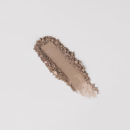 Pressed eyeshadow swatch in warm brown taupe with glittery, textured powder