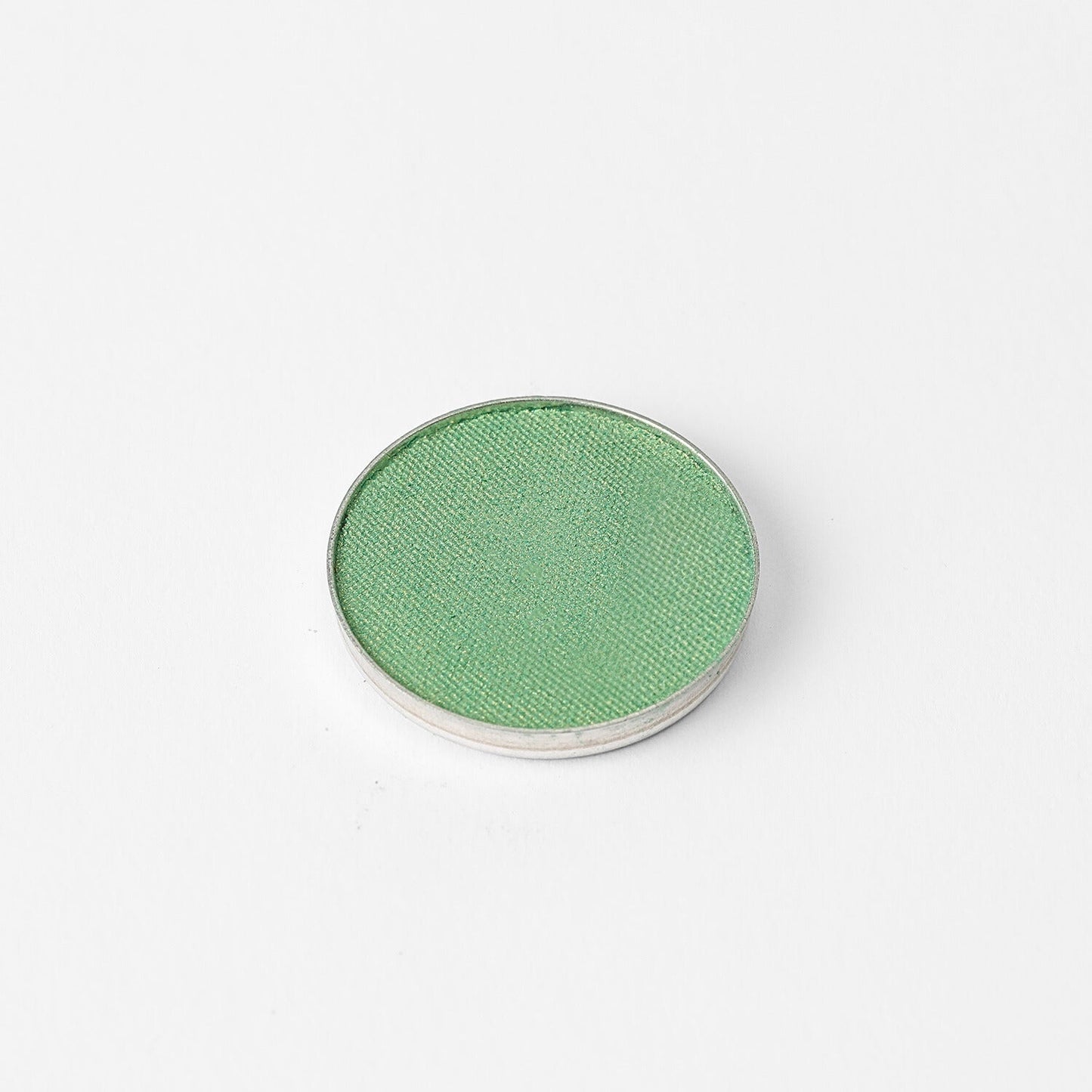 Pressed eyeshadow pan, bright green shimmer finish